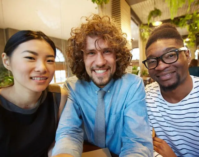 Three friends smiling together