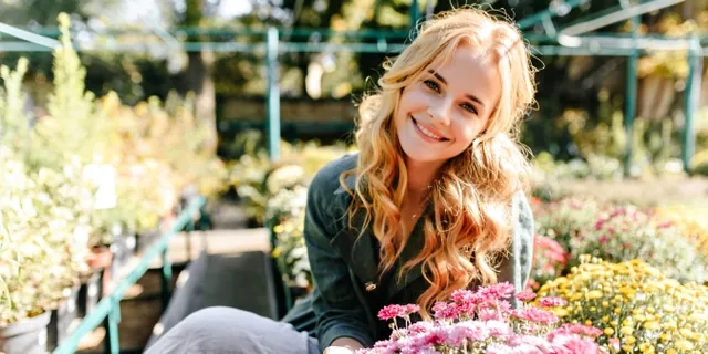 A woman browsing plants at a flower shop
