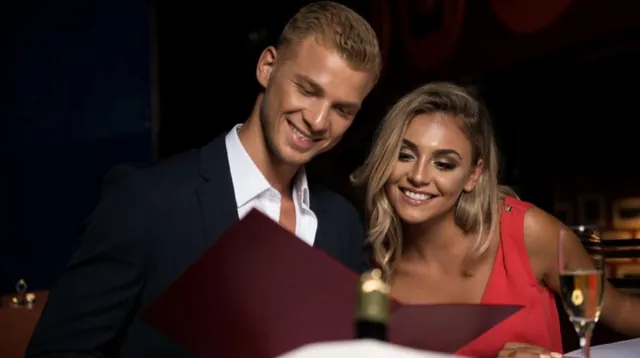 A couple looking at a restaurant menu