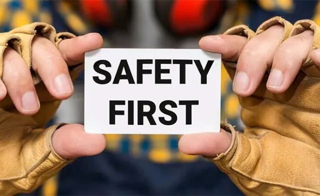 A person holding a Safety First sign
